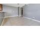 Open living room featuring tile flooring and neutral paint scheme with easy access to the kitchen area at 8317 N Marks St, Tampa, FL 33604