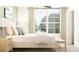 Cozy bedroom boasts a plush bed, soft lighting, and a view of the outdoors through a large window at 8518 Sea Ray Run, Parrish, FL 34219