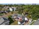 Aerial view of home with tiki hut, umbrellas, sheds and mature trees in a quiet neighborhood at 905 W Fribley St, Tampa, FL 33603