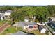 Aerial view of home with a patio that has a tiki hut and red and blue umbrellas plus two sheds at 905 W Fribley St, Tampa, FL 33603