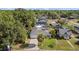 Aerial view of a well-maintained home with a lush yard, featuring a driveway and mature trees at 905 W Fribley St, Tampa, FL 33603