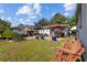 Spacious backyard with lush lawn, brick patio, and outdoor seating areas for relaxing and entertaining at 905 W Fribley St, Tampa, FL 33603