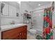 Clean bathroom with a single vanity, neutral colored tile flooring, and shower/tub combo at 905 W Fribley St, Tampa, FL 33603