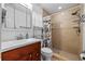 Bathroom featuring tiled stand-up shower, vanity sink, and fixtures at 905 W Fribley St, Tampa, FL 33603