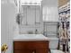 Bathroom featuring tiled stand-up shower, vanity sink, and fixtures at 905 W Fribley St, Tampa, FL 33603