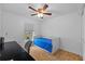 Bright bedroom with a ceiling fan, and hardwood floors, features a small bed at 905 W Fribley St, Tampa, FL 33603