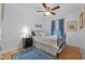 Cozy bedroom featuring wood floors, stylish rug, ceiling fan, and bright natural light at 905 W Fribley St, Tampa, FL 33603