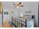 Comfortable bedroom with wood floors, ceiling fan, decorative artwork, and bright natural light at 905 W Fribley St, Tampa, FL 33603