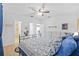 Comfortable bedroom with ceiling fan featuring attached bath and dresser storage at 905 W Fribley St, Tampa, FL 33603