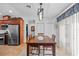Bright dining area adjacent to the kitchen, featuring a wooden table, matching chairs, and a modern light fixture at 905 W Fribley St, Tampa, FL 33603