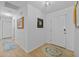 Bright hallway with wood-look floors, white walls, and decorative rugs creating a welcoming entrance at 905 W Fribley St, Tampa, FL 33603