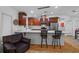 Charming kitchen featuring an island with seating, stainless appliances, and warm wood cabinetry at 905 W Fribley St, Tampa, FL 33603