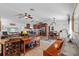 Open-concept living room with wood-look flooring, modern furnishings, and a seamless flow into the kitchen and dining area at 905 W Fribley St, Tampa, FL 33603