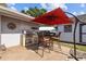 Outdoor kitchen with built-in grill and bar seating on a brick patio, ideal for outdoor cooking at 905 W Fribley St, Tampa, FL 33603