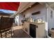 Modern outdoor kitchen equipped with grill, countertop, and refrigeration on brick patio at 905 W Fribley St, Tampa, FL 33603
