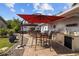 Brick patio featuring an outdoor kitchen, a dining table, and umbrellas providing shade for enjoyable outdoor living at 905 W Fribley St, Tampa, FL 33603