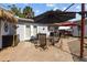 Enjoy outdoor living on this brick patio featuring a dining set, grill, and shade umbrellas at 905 W Fribley St, Tampa, FL 33603
