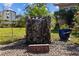 Relaxing water feature with stone surround, adding a touch of serenity to the landscape at 905 W Fribley St, Tampa, FL 33603