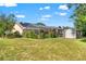 Spacious backyard showcases the screened-in patio, lawn, and storage shed at 9202 Jena Rd, Spring Hill, FL 34608