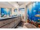 Spacious bathroom with a double vanity, ocean-themed shower curtain, and plenty of storage at 9202 Jena Rd, Spring Hill, FL 34608