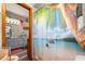 Bathroom with a tropical-themed shower curtain and a vanity with marble-look countertop at 9202 Jena Rd, Spring Hill, FL 34608