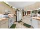 Cozy kitchen features tile flooring, white appliances, and ample cabinet space for storage at 9202 Jena Rd, Spring Hill, FL 34608
