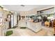Bright kitchen featuring tile floors, white cabinets and appliances, seamlessly flowing into the living area at 9202 Jena Rd, Spring Hill, FL 34608