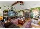 Comfortable living room with a stone fireplace, TV, and cozy seating area at 9202 Jena Rd, Spring Hill, FL 34608