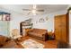 Relaxing living room area with a pull-out sofa, ceiling fan, and cozy decor at 9202 Jena Rd, Spring Hill, FL 34608