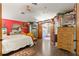 Bright main bedroom with wood floors, floral accents, and a view into the main bath at 9202 Jena Rd, Spring Hill, FL 34608