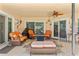 Cozy outdoor patio area features comfortable wicker furniture and a ceiling fan at 9202 Jena Rd, Spring Hill, FL 34608