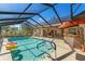 An angled view of the pool with inflatables, showing the full screened-in enclosure at 9202 Jena Rd, Spring Hill, FL 34608