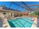 Stunning screened pool area with outdoor bar, floats, and ample space for relaxation and entertainment at 9202 Jena Rd, Spring Hill, FL 34608