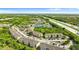 Aerial view of the community near a highway and lake, surrounded by lush greenery at 9519 Newdale Way # 202, Riverview, FL 33578