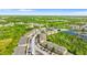Scenic aerial view of community, showcasing lush landscaping, and a community pool by a lake at 9519 Newdale Way # 202, Riverview, FL 33578