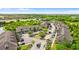 An aerial view showcases the community layout and surrounding landscape with lush greenery and a nearby lake at 9519 Newdale Way # 202, Riverview, FL 33578
