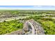 Aerial view of the community near a highway and lake surrounded by lush greenery with location pin at 9519 Newdale Way # 202, Riverview, FL 33578