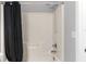 Bright bathroom featuring a shower and tub combination with a black shower curtain at 9519 Newdale Way # 202, Riverview, FL 33578