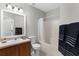 Well-lit bathroom featuring a sink, toilet, shower with curtain, and decorative towels at 9519 Newdale Way # 202, Riverview, FL 33578