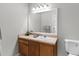 Bathroom vanity with framed mirror, cabinet storage, and neutral counter tops at 9519 Newdale Way # 202, Riverview, FL 33578