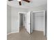 Bedroom featuring neutral walls, tile flooring, ceiling fan, and an entrance to another room at 9519 Newdale Way # 202, Riverview, FL 33578