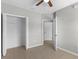 Bedroom featuring neutral walls, tile flooring, ceiling fan, closet, and an entrance to another room at 9519 Newdale Way # 202, Riverview, FL 33578