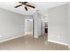 Spacious bedroom featuring tile floors, a ceiling fan, and access to closets and bathroom at 9519 Newdale Way # 202, Riverview, FL 33578