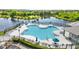 Inviting community pool area with ample lounge chairs and lush landscaping at 9519 Newdale Way # 202, Riverview, FL 33578