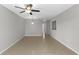 Clean, open living room featuring neutral walls, tile floors, and overhead lighting at 9519 Newdale Way # 202, Riverview, FL 33578