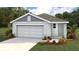 Charming single-story home with a two-car garage, landscaped yard, and a welcoming front entrance at 1010 Spotted Egret Loop, Ruskin, FL 33570