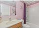 Charming pink bathroom with floral accents, featuring a shower-tub combo and classic vanity at 10311 Frog Pond Dr, Riverview, FL 33569