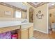Well-appointed bathroom with vanity, framed mirror and decorative accents on the walls at 10311 Frog Pond Dr, Riverview, FL 33569