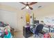 Bedroom with neutral walls and ceiling fan, showcasing double closet doors and a light-filled interior at 10311 Frog Pond Dr, Riverview, FL 33569