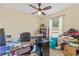 Bedroom features a ceiling fan, natural light from the window, and space for functional use at 10311 Frog Pond Dr, Riverview, FL 33569